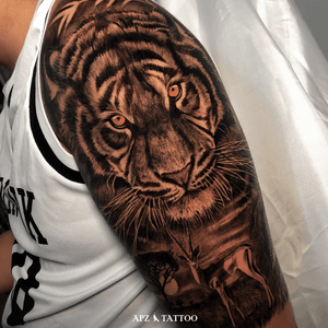 Tiger Tattoo in Black and Gray Realism on Arm by APZ in Copenhagen, Denmark. In Copenhagen, APZ, a world-class tattoo artist, crafts modern black and gray realism tattoos. His tiger piece on an arm speaks volumes with its lifelike realistic details. APZ’s talent travels from Copenhagen to New York to Dubai, leaving impactful, soulful marks wherever he goes. Want to get a unique reminder? APZ is here to help you. Explore his portfolio on Instagram: @apztattoo. #surrealism #realism #black&gray #tattoodoambassador #blackandgray #realism #surrealism #microrealism