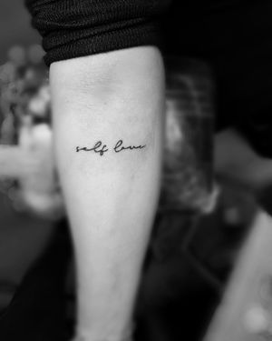 Elegant and delicate small lettering design, perfect for a subtle and meaningful tattoo. Book your appointment now!