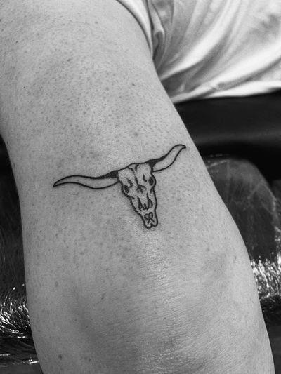 Get a stunning illustrative tattoo of a cow skull by the talented artist Laurel. Unique and edgy design that will stand out.