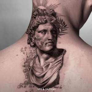 Portrait of the God Apollo in a black and gray realism tattoo on the nape, done by the tattoo artist APZ in Copenhagen, Denmark. In Copenhagen, APZ, a world-class tattoo artist, crafts modern black and gray realism portraits. His Apollo piece on a nape speaks volumes with its lifelike realistic details. APZ’s talent travels from Copenhagen to New York to Dubai, leaving impactful, soulful marks wherever he goes. Want to get a unique reminder? APZ is here to help you. Explore his portfolio on Instagram: @apztattoo. #surrealism #realism #black&gray #tattoodoambassador #blackandgray #realism #surrealism