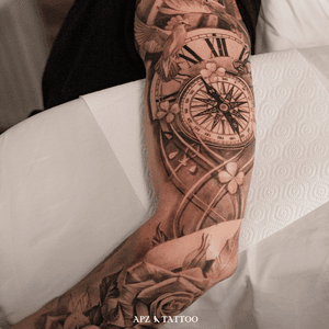 Tattoo of a compass and roses in a black and gray realism technique on the full arm (sleeve), done by the tattoo artist APZ in Copenhagen, Denmark. In Copenhagen, APZ, a world-class tattoo artist, crafts modern black and gray realism tattoos. His compass and roses piece on a full arm sleeve speaks volumes with its lifelike realistic details. APZ’s talent travels from Copenhagen to New York to Dubai, leaving impactful, soulful marks wherever he goes. Want to get a unique reminder? APZ is here to help you. Explore his portfolio on Instagram: @apztattoo. #surrealism #realism #black&gray #tattoodoambassador #blackandgray #realism #surrealism #microrealism