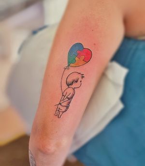 Celebrate autism awareness with this heartwarming illustrative tattoo featuring a kid motif by Larisa Andreea Boboc.