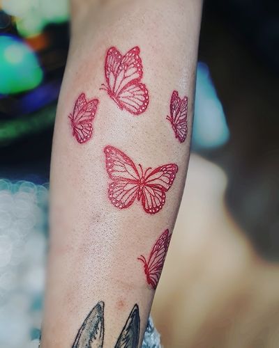 Add a pop of color to your skin with Larisa Andreea Boboc's illustrative butterfly design in striking red ink.