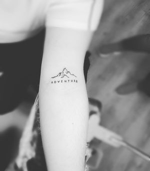 Get a stunning fine line mountain tattoo with small lettering and illustrative style by the talented artist Larisa Andreea Boboc. Perfect for nature lovers!