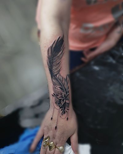 Get a stunning feather tattoo with intricate ornamental details done by the talented artist Larisa Andreea Boboc.