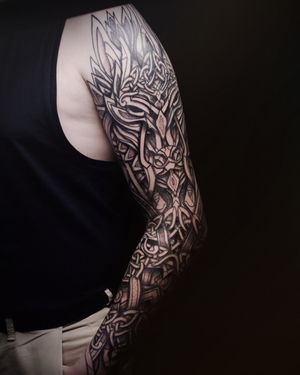 "Behold the artful dance of Viking symbolism and contemporary flair, captured in this evocative tattoo."
