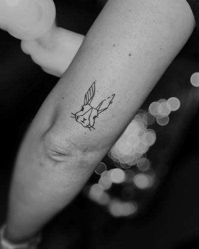 Get a sleek and modern fine line geometric rabbit tattoo by the talented artist Larisa Andreea Boboc.