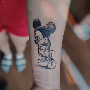 Check out this vibrant and creative illustrative tattoo featuring Mickey Mouse, created by the talented artist Larisa Andreea Boboc.