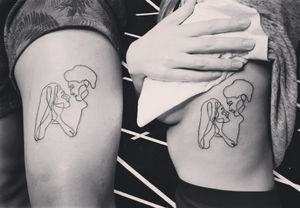 Get inked with this delicate fine line couple tattoo by Larisa Andreea Boboc, showcasing love in its simplest form.
