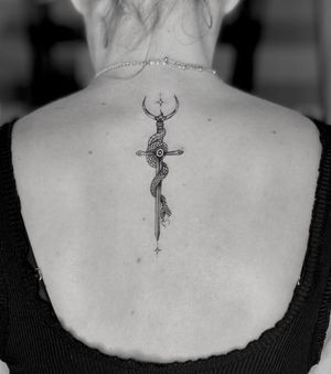 Stunning illustrative tattoo featuring a snake and a sword, created by the talented artist Ruth Hall.