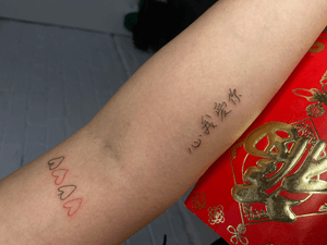 This exquisite tattoo features delicate small lettering in the form of a Kanji motif, expertly done by Ruth Hall.
