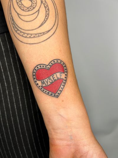 Get a timeless traditional heart tattoo designed by Claudia Trash for a bold and striking look.