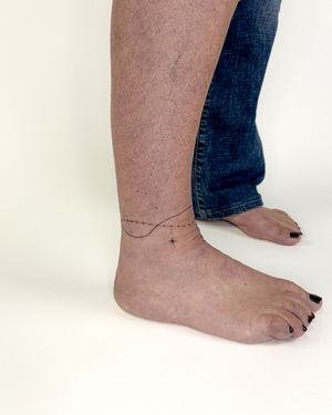 Beautiful and dainty tattoo on the ankle, created with fine line technique by Bradley Mollett.