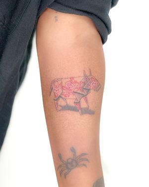 Get inked with illustrative tattoo by Bradley Mollett featuring a unique blend of dog, origami, and porcelain elements in bold red hues.