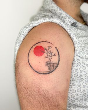 Experience the beauty of nature with this unique illustrative tattoo by Bradley Mollett, featuring a sun, bonsai tree, and enso symbol.