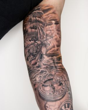 Explore the depths of the sea with this black and gray illustrative tattoo featuring a compass and ship by Bradley Mollett.