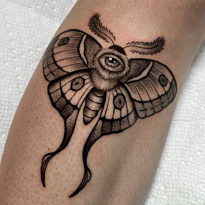 Unique blackwork and dotwork design by tattoo artist Andrew Garinther, merging a moth and an eye in an illustrative style.