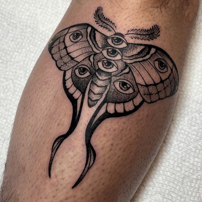 Experience the intricate beauty of blackwork and dotwork in this illustrative tattoo featuring a moth and eye design by Andrew Garinther.