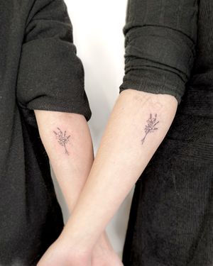 Elegant fine line illustrative tattoo featuring a beautiful flower bundle, expertly done by tattoo artist Bradley Mollett.