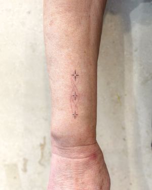 Discover the delicate and dainty beauty of this fine line tattoo by the talented artist Bradley Mollett.