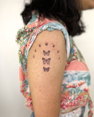 Illustrative black and gray tattoo by Bradley Mollett featuring moon phases, butterfly, and scar coverup.
