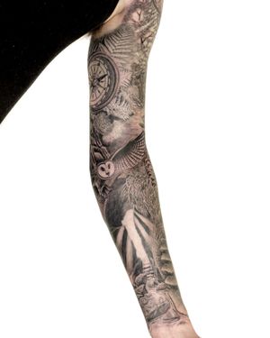 Black and gray tattoo by Bradley Mollett, featuring a majestic owl and compass set in a mystical forest.