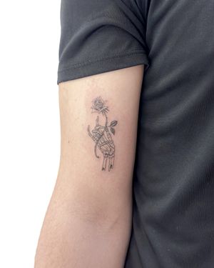 Fine line illustrative tattoo by Bradley Mollett featuring a beautiful rose intertwined with a skeletal hand design.