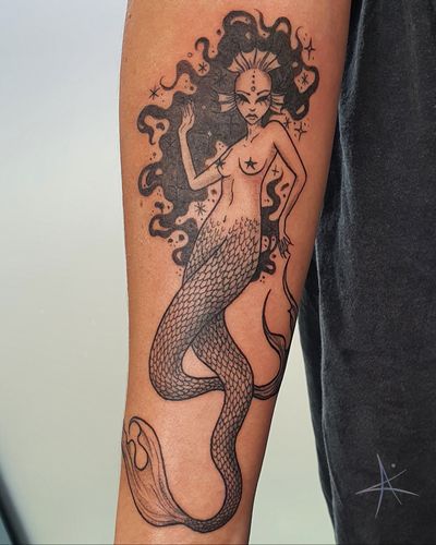 Get mesmerized by this illustrative tattoo of a beautiful mermaid siren, created by the talented artist AmaaNitaa.