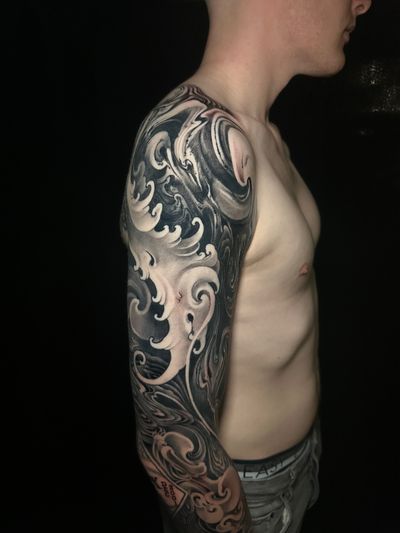 Dive into the beauty of the ocean with this stunning illustrative wave tattoo by Avi. Perfect for ocean lovers!