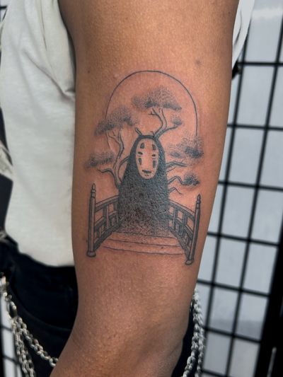Get lost in the magic of Studio Ghibli with this enchanting anime tattoo featuring the iconic No Face character. Skillfully inked by Jonathan Glick.
