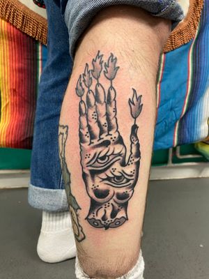 Traditional black and grey eye hand on fire 