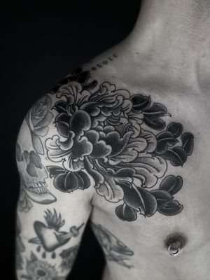 Elegant and detailed blackwork flower tattoo by Lukey Wolf. Perfect for those seeking a unique and artistic design.