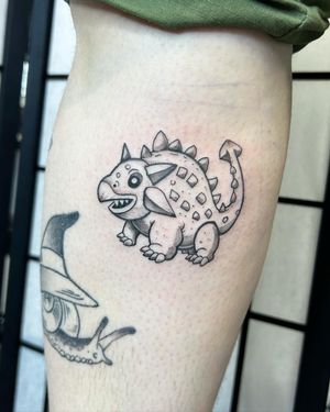 Explore the prehistoric world with this illustrative dinosaur tattoo by Jonathan Glick. Perfect for any Jurassic enthusiast.