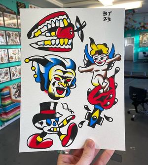 Traditional colour flash featuring a cherub and a sacred heart, flash teeth holding a cherry, theatre mask and a skull with legs and a top hat 