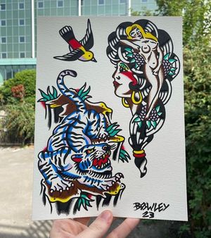 Traditional colour flash featuring a tiger on rocks, lady pinup in a lady head and a swallow 