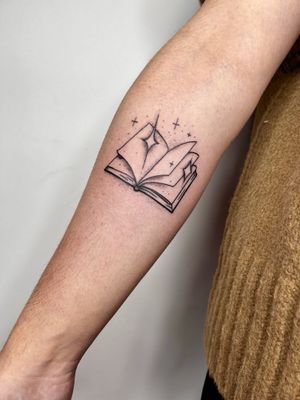 Get inked with a captivating illustrative book tattoo by the talented artist Jonathan Glick. Express your love for literature in style.