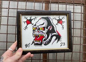 Traditional colour flash featuring an Ed hardy gorilla head and bullet holes 