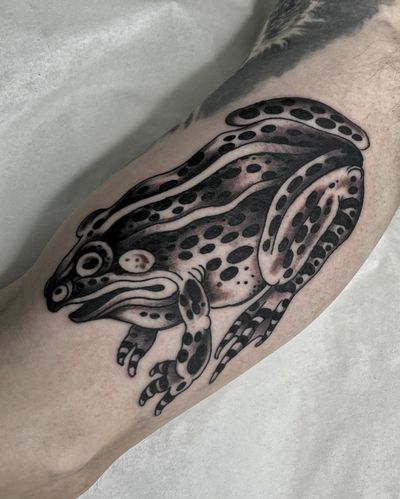 Get a standout illustrative blackwork frog tattoo to make a statement, expertly done by the talented artist Lukey Wolf.