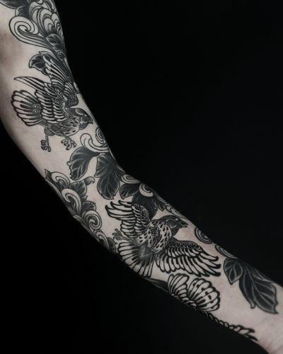 A stunning illustrative bird tattoo by Lukey Wolf, showcasing intricate blackwork design.