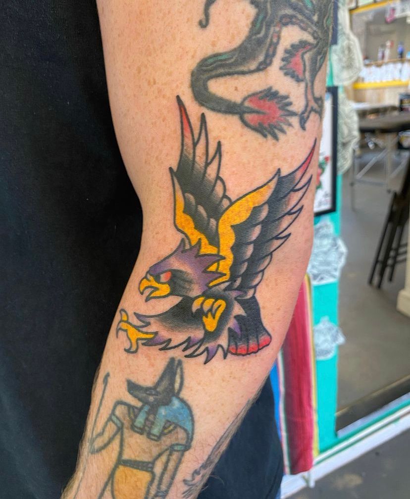Simple celtic Eagle with wings spread upwards. Colourful background,  splashes on colour tattoo idea | TattoosAI