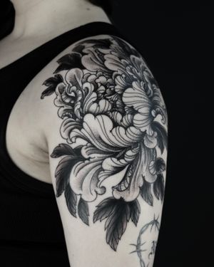 Stunning blackwork tattoo of a flower designed by Lukey Wolf, featuring intricate illustrative details.