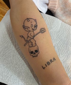 Get inked with a striking illustrative tattoo featuring a devilish twist on a classic skull motif by Julia Bertholdi.