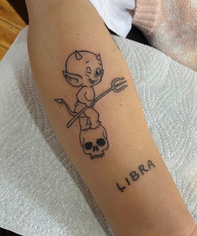 Get inked with a striking illustrative tattoo featuring a devilish twist on a classic skull motif by Julia Bertholdi.