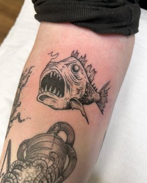 Unique angler fish design by artist Jonathan Glick, perfect for those who love ocean creatures and intricate tattoo work.