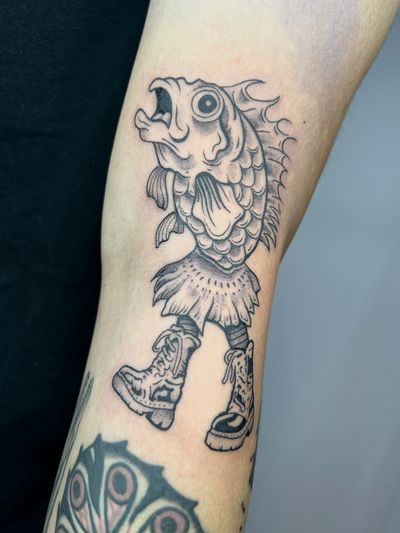 Unique tattoo design combining a fish and shoes motif, created by Jonathan Glick. Perfect for those who love both marine life and fashion.