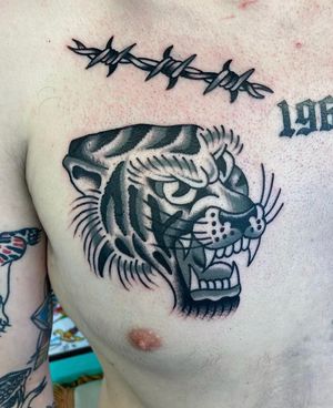 Traditional black and grey Tiger head and barbed wire 