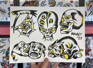 Traditional colour flash featuring an alien head, skull, laugh now cry later theatre masks, bulldog and cobweb branch