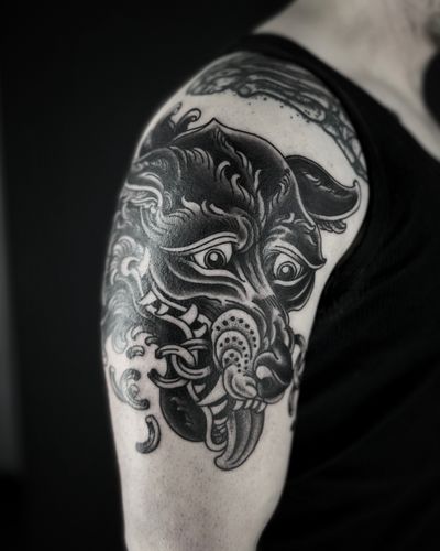 Unique illustrative tattoo of a dog and wolf by the talented artist Lukey Wolf. Detailed blackwork design.