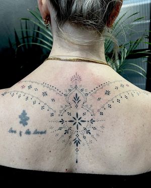 Elegant ornamental tattoo by Indigo Forever Tattoos, created with delicate hand-poked dotwork technique.