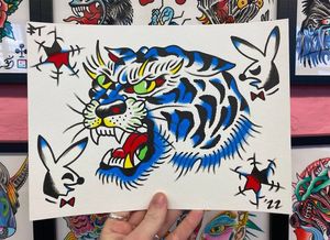 Traditional colour flash featuring a large ice tiger head, playboy bunnies and bullet holes 